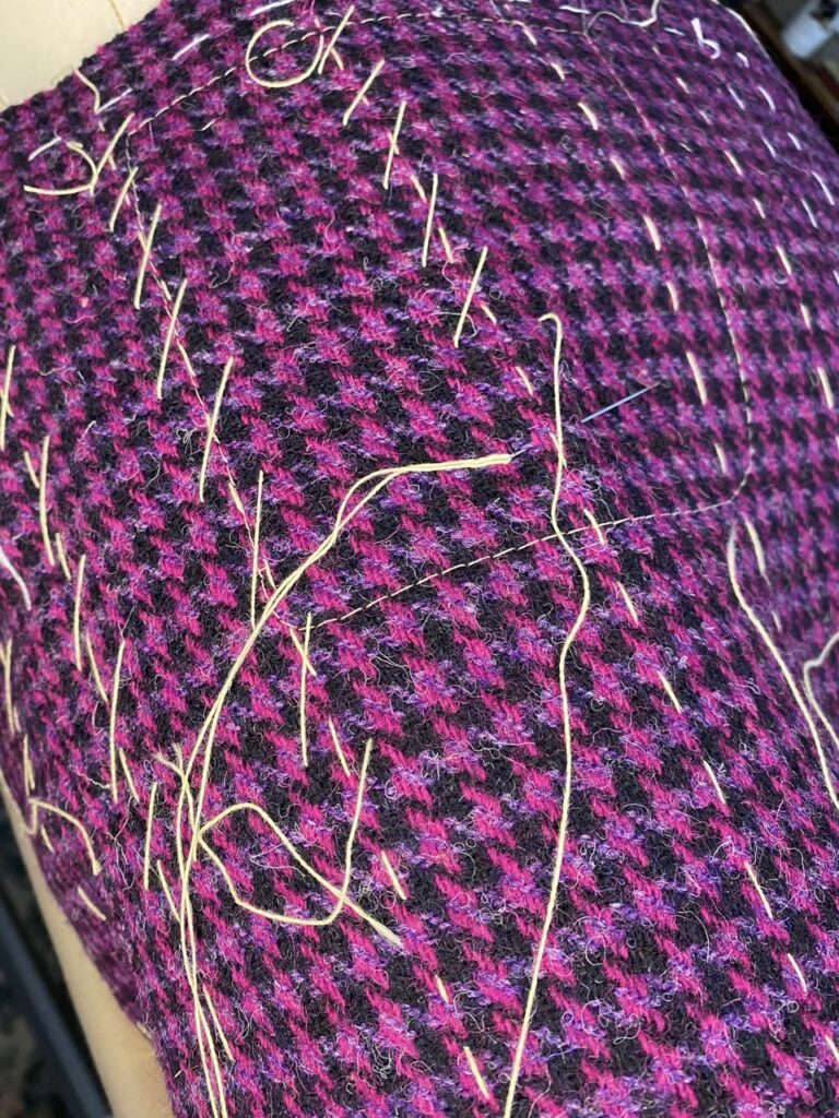 Matelassage à la main d’une veste en Harris Tweed afin de préserver la souplesse naturelle du tissu.